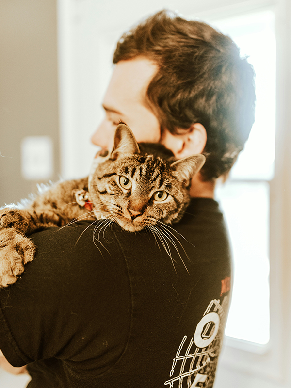 A cat being held by a man